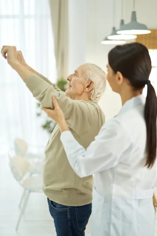 Female doctor helping an elderly man to do exercis 2025 03 25 13 40 08 utc